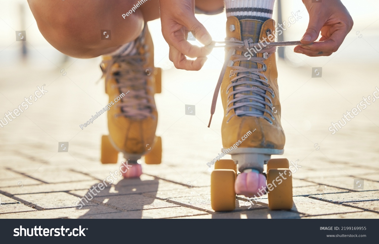 Yellow roller skates shoes of woman in summer outdoor travel, journey or fun activity for the holiday. Cool, trendy or funky gen z person prepare or tie laces on ground in quad skating with sunshine #2199169955