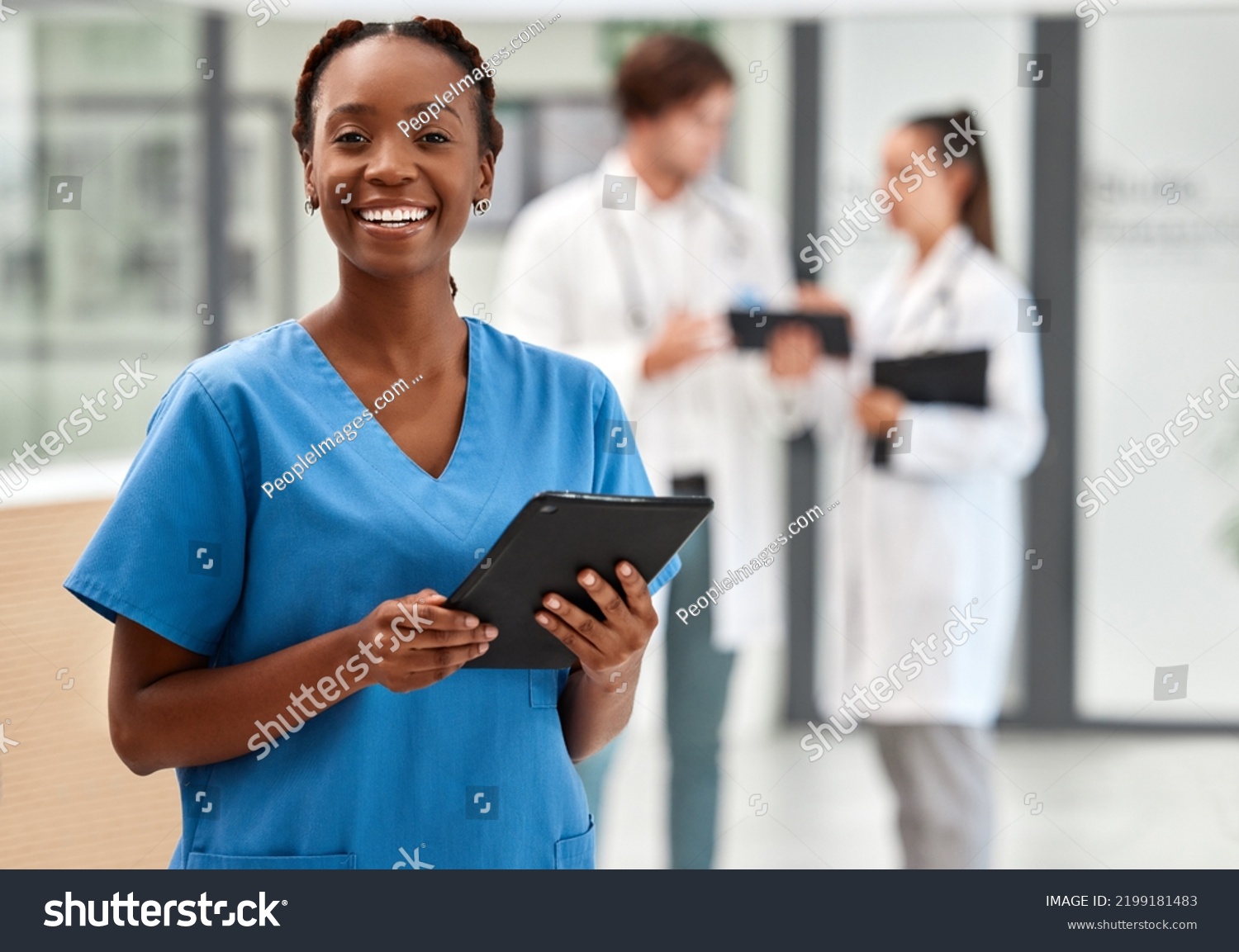Portrait of happy woman doctor working on a digital tablet and smile while working at a hospital. Black female nurse doing medical and healthcare research on the internet or online at work at clinic #2199181483