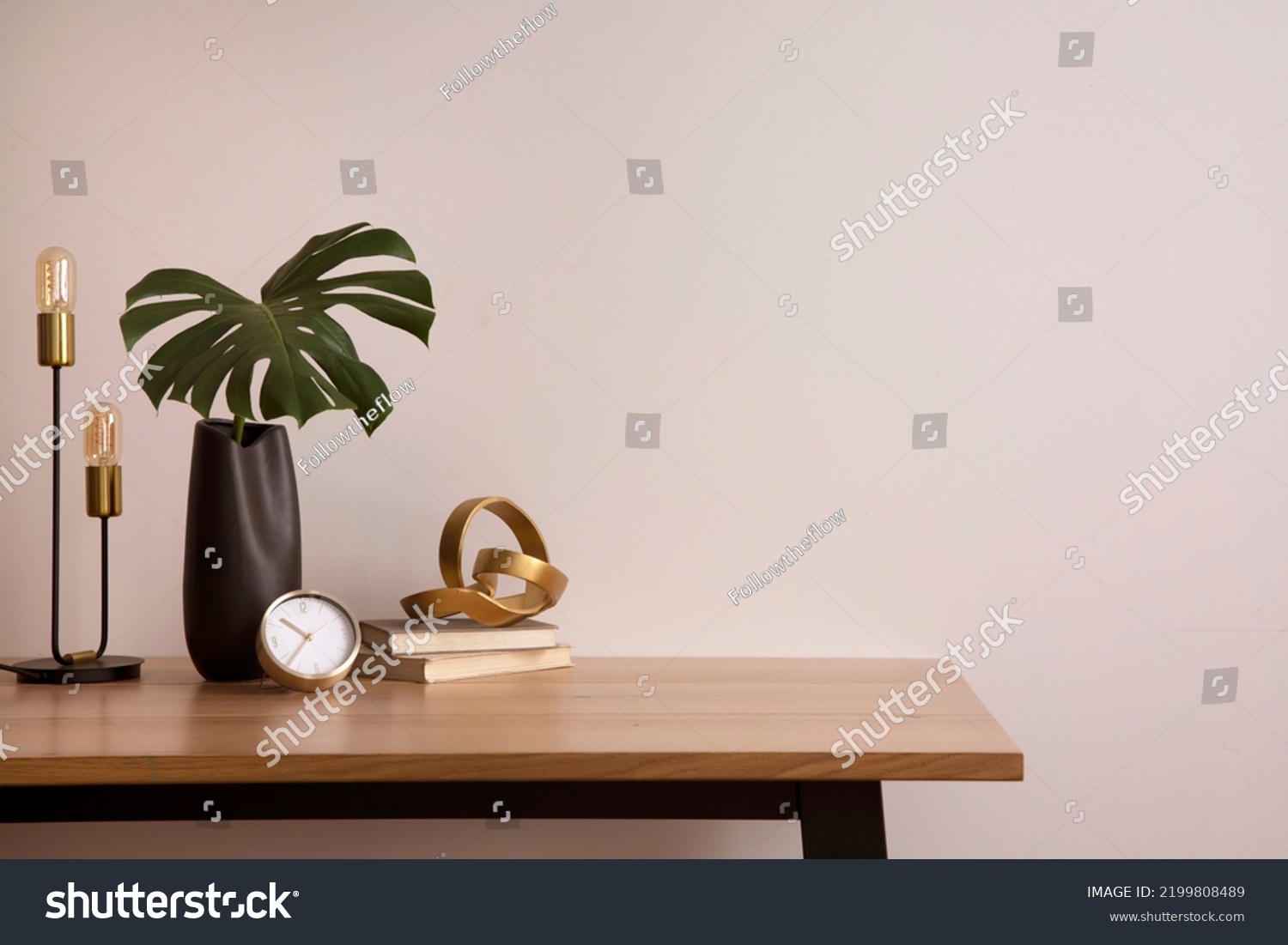 Minimalist composition of elegant home office space with design chair, black vase with leaf, sculpture, book and personal accessories. Copy space. Minimalist home decor. Template.	
 #2199808489