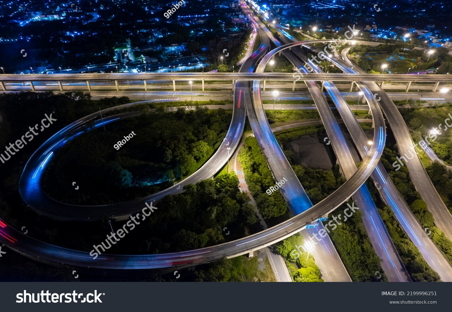 Aerial view of road interchange or highway intersection of Expressway top view, Road traffic an important infrastructure, car traffic transportation above intersection road in city night. #2199996251