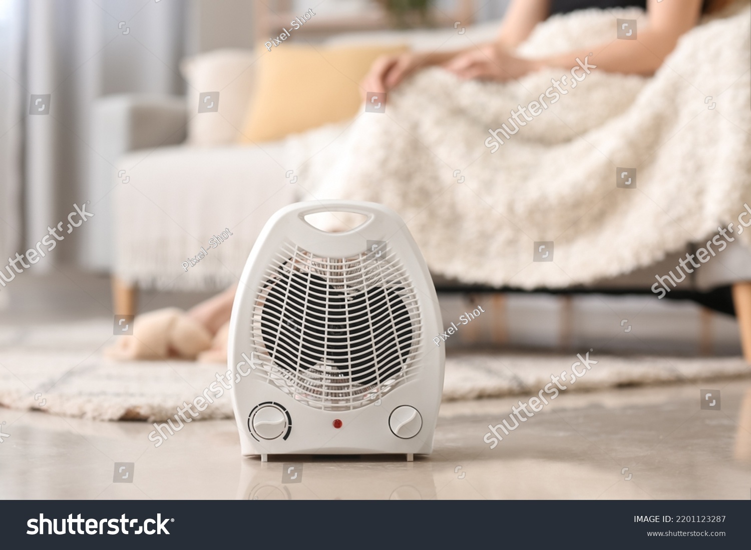 Electric fan heater on floor in living room, closeup #2201123287