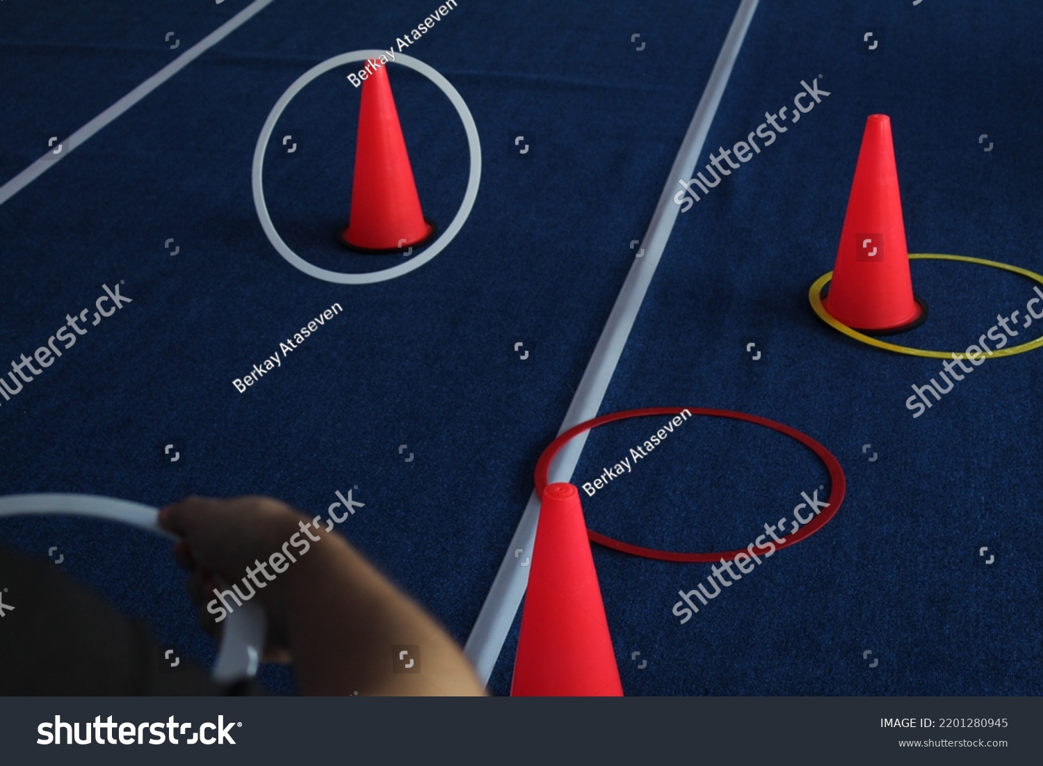 Some throw rings to red cones. Game for children . High quality photo #2201280945