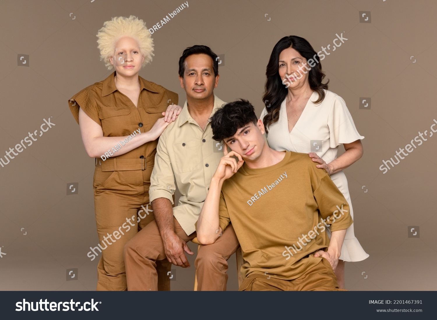 Portrait of a Black woman with albinism in her 20's, a Hispanic woman in her 50's, a non-binary Caucasian person in their 20's, and an Indian man in his 50's looking at the camera. #2201467391