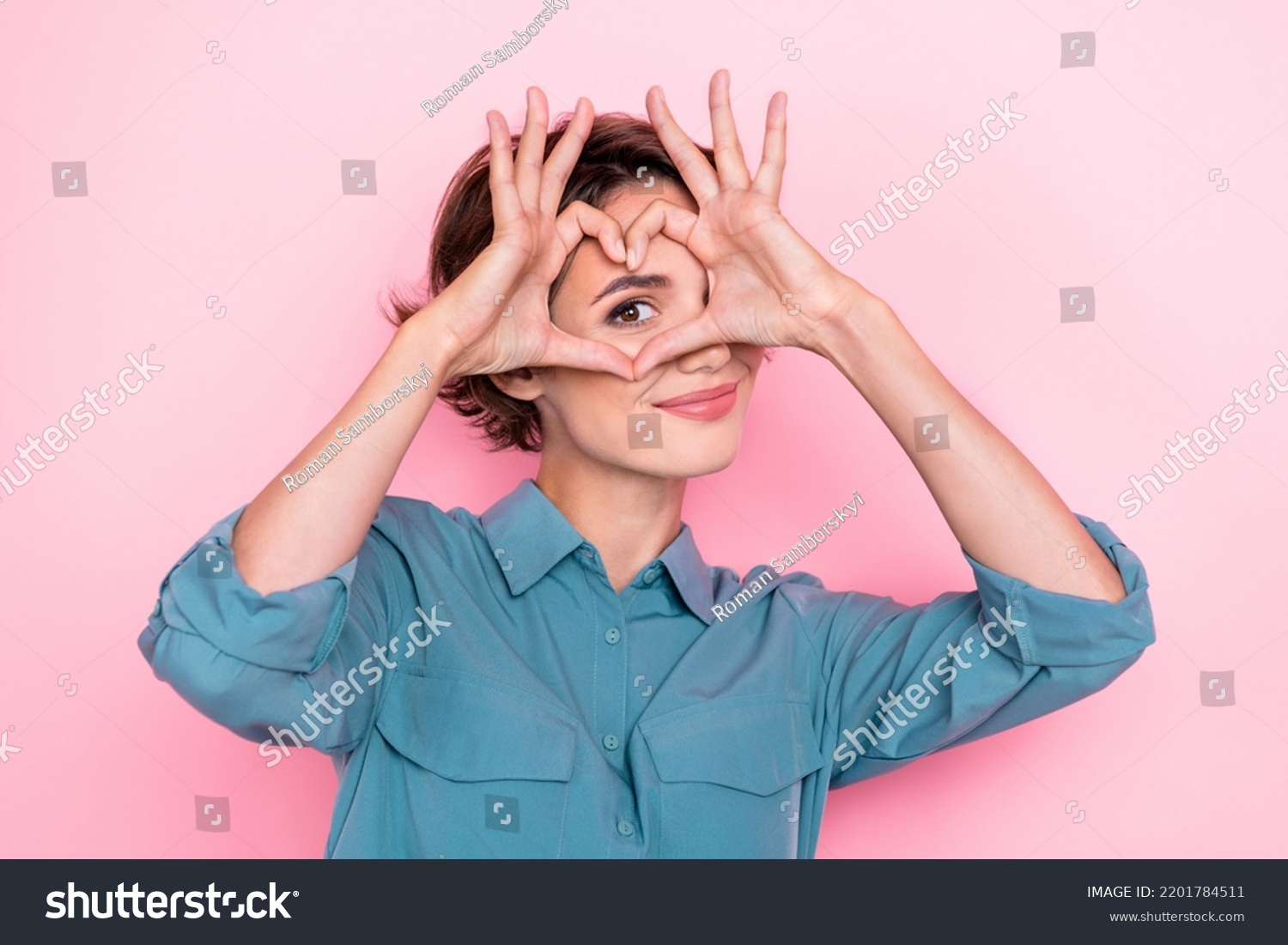Portrait of adorable nice person arms fingers demonstrate heart symbol eye isolated on pink color background #2201784511