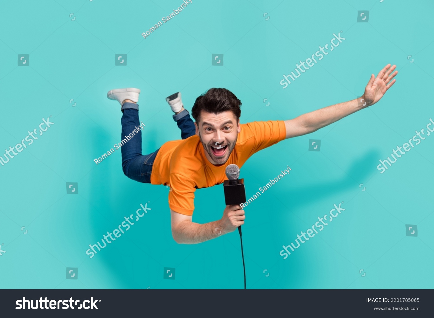 Full size photo of active guy reporter hold mic tell news on tv video show isolated on cyan color background #2201785065