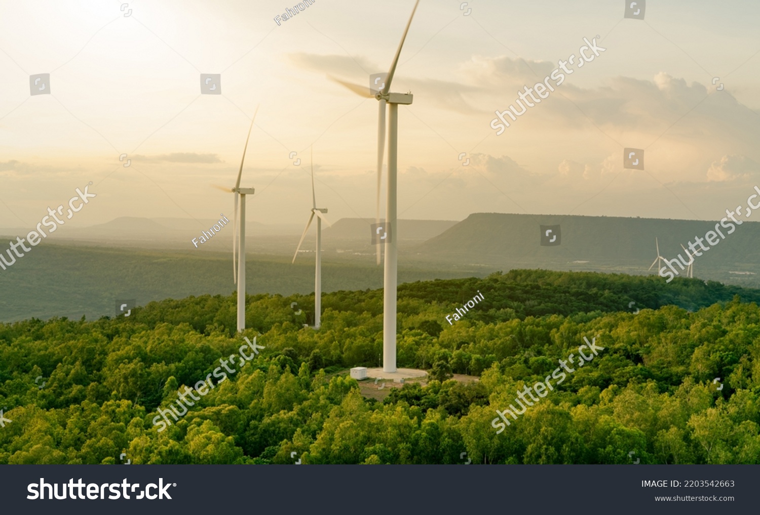 Selective focus on wind farm. Wind energy. Wind power. Sustainable, renewable energy. Wind turbines generate electricity. Windmill farm on mountain. Green technology. Sustainable resources. #2203542663
