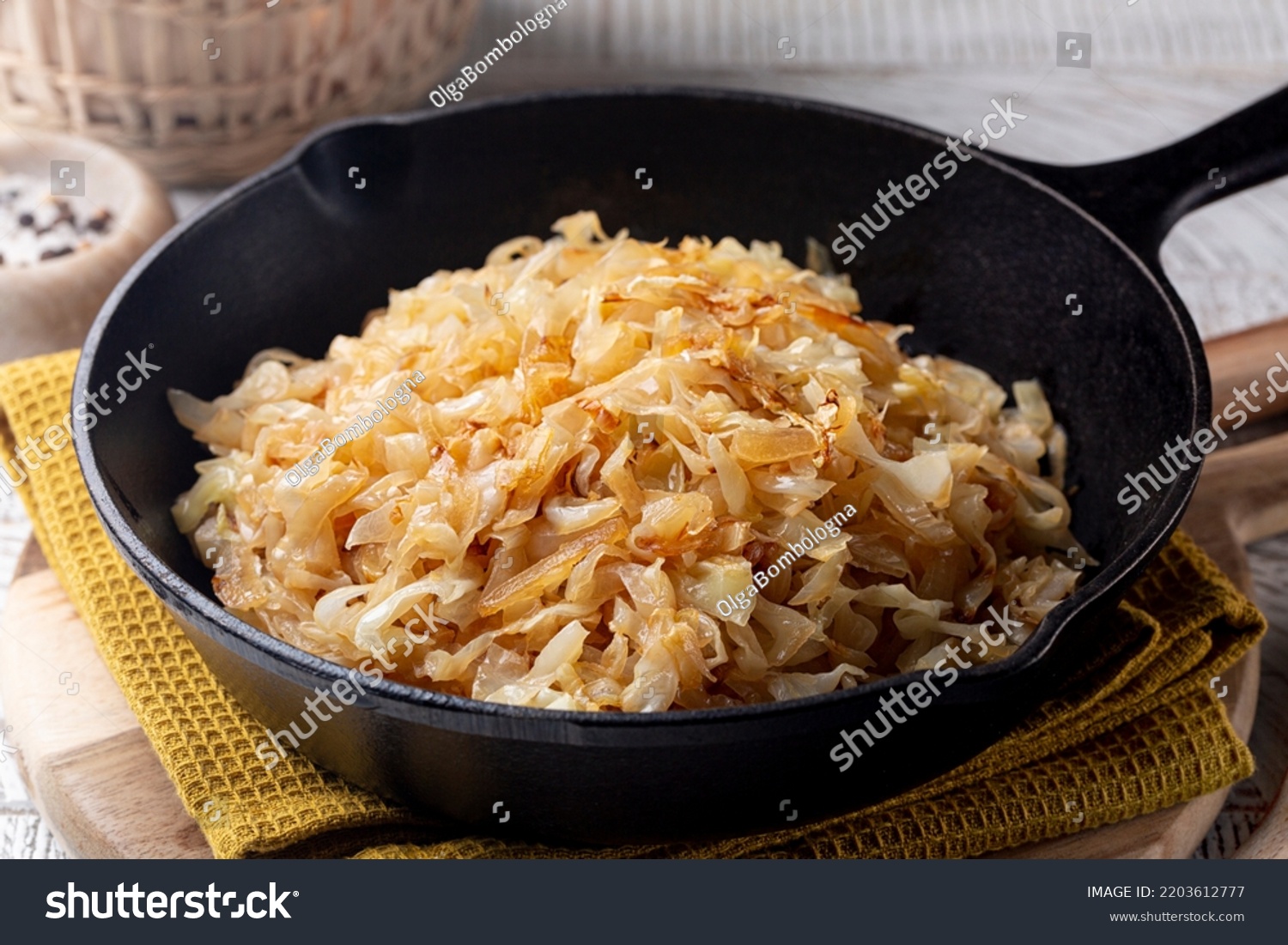 Quick Pan fried Sauerkraut or Crauti. Finely cut white cabbage cooked with fried onion and white wine. Close-up. #2203612777