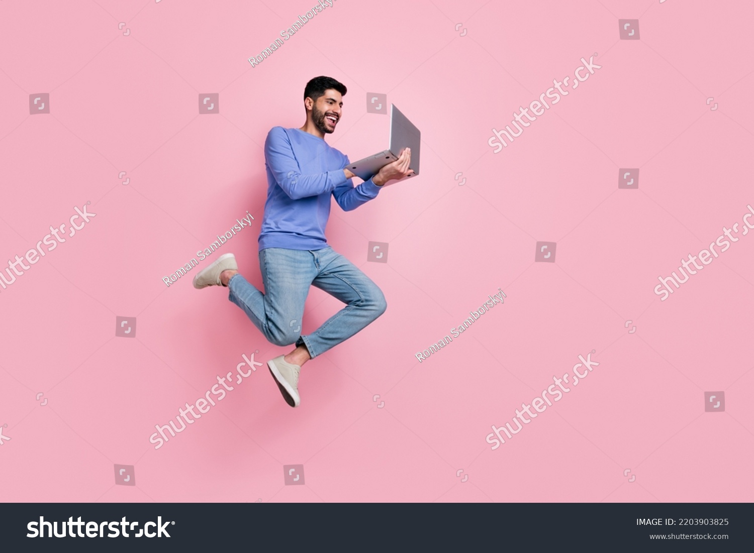 Full length photo of funny pretty guy dressed blue pullover jumping high typing modern device isolated pink color background #2203903825