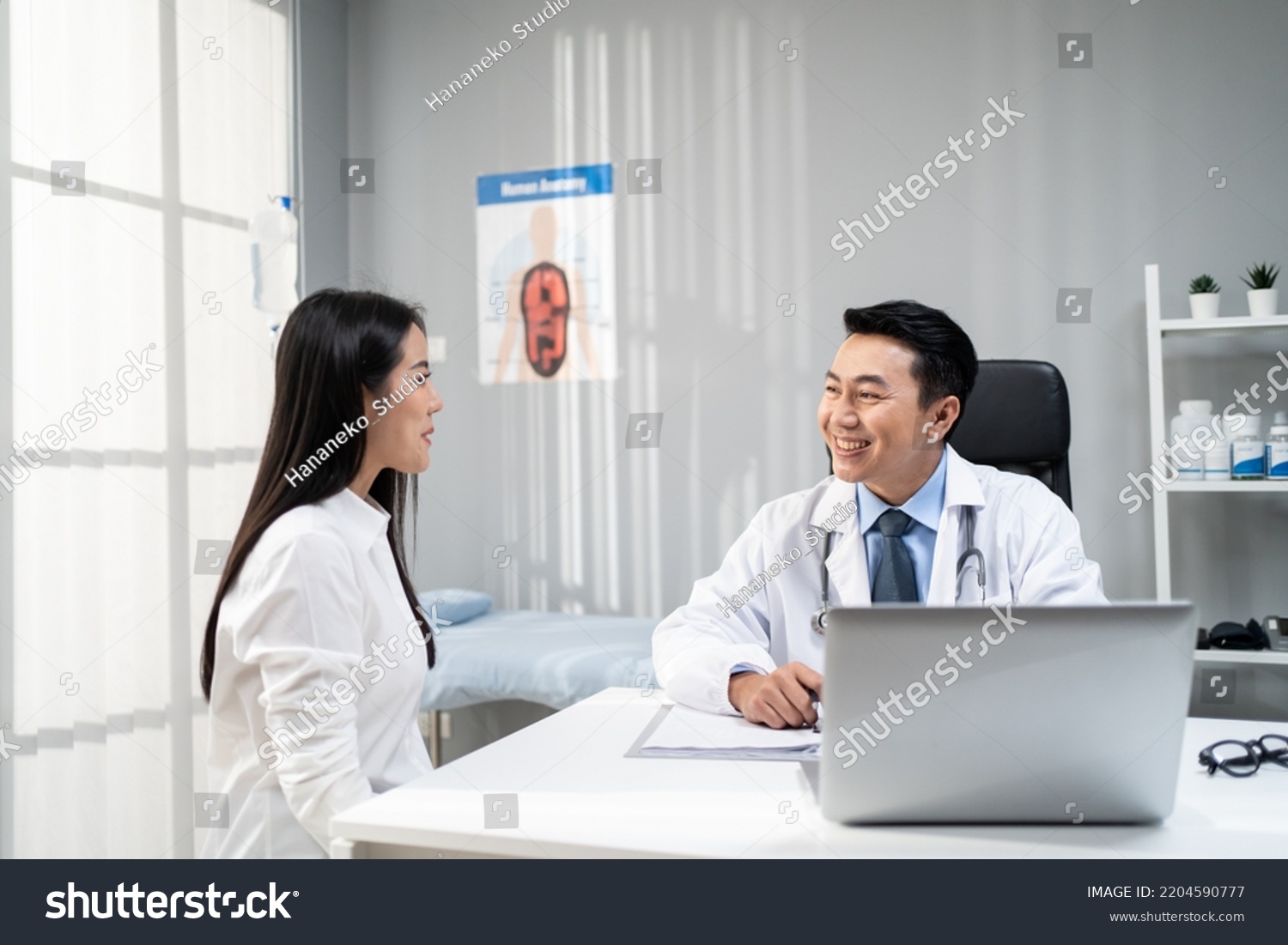 Asian woman patient visit and consult health problem with young doctor. Attractive therapist practitioner work to explain diagnosis in office hospital to give treatment to sick girl during appointmen #2204590777