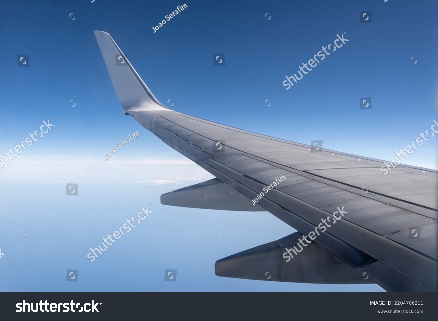 View from the inside or interior of the airplane. Airplane porthole window view from the passenger seat #2204706211