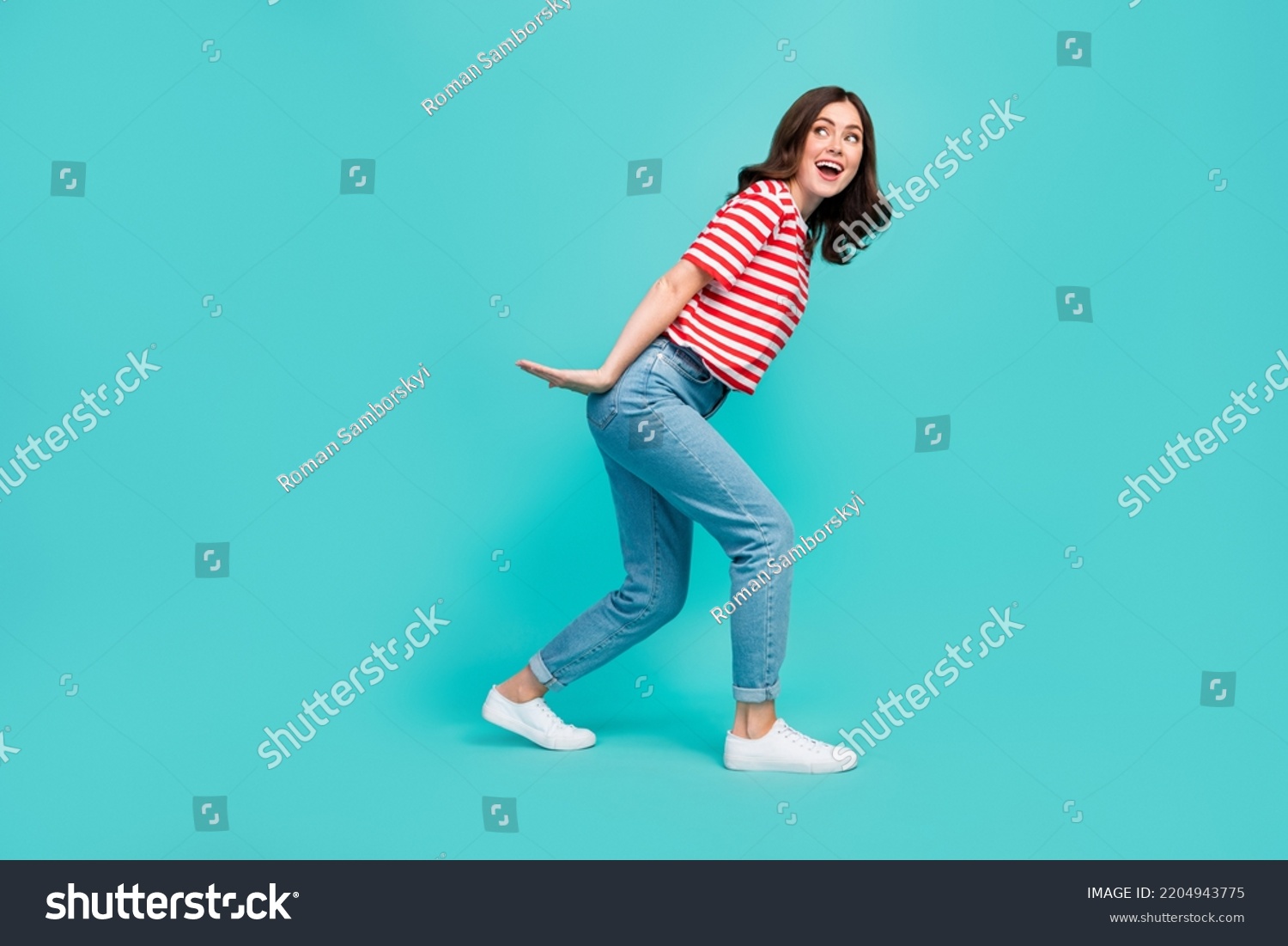 Full length photo of crazy pretty lady arm hold big size ad carry look empty space striped stylish wear isolated on cyan color background #2204943775