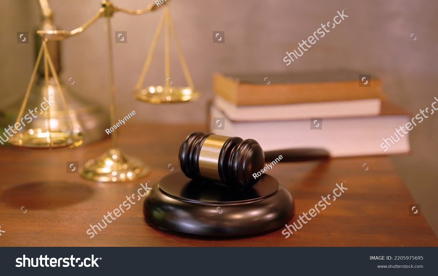 Lawyer or judge's hammer in the court. Auction's hammer is on woo table. Law subject or auction firm with book and golden judge's scale as symbol. #2205975695