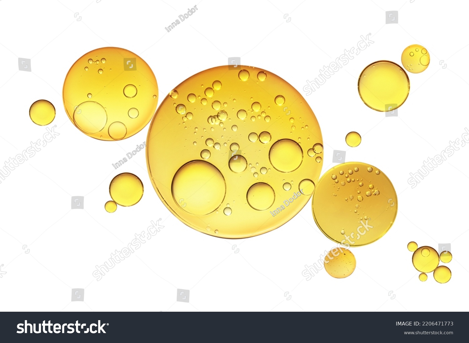 Golden yellow abstract oil bubbles or face serum isolated on white background. Oil bubbles macro photography. #2206471773
