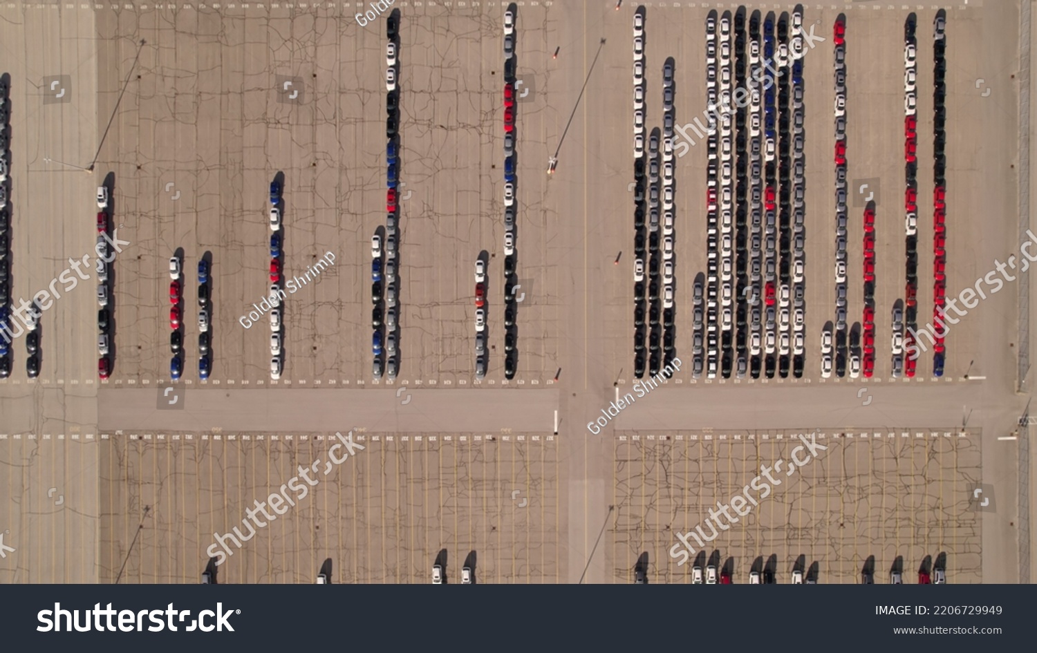 Aerial view of car storage or parking lot new unsold EV cars. Vehicle automaker and manufacturer parking facility. Low carbon footprint EV electric cars are ready for further distribution.  #2206729949