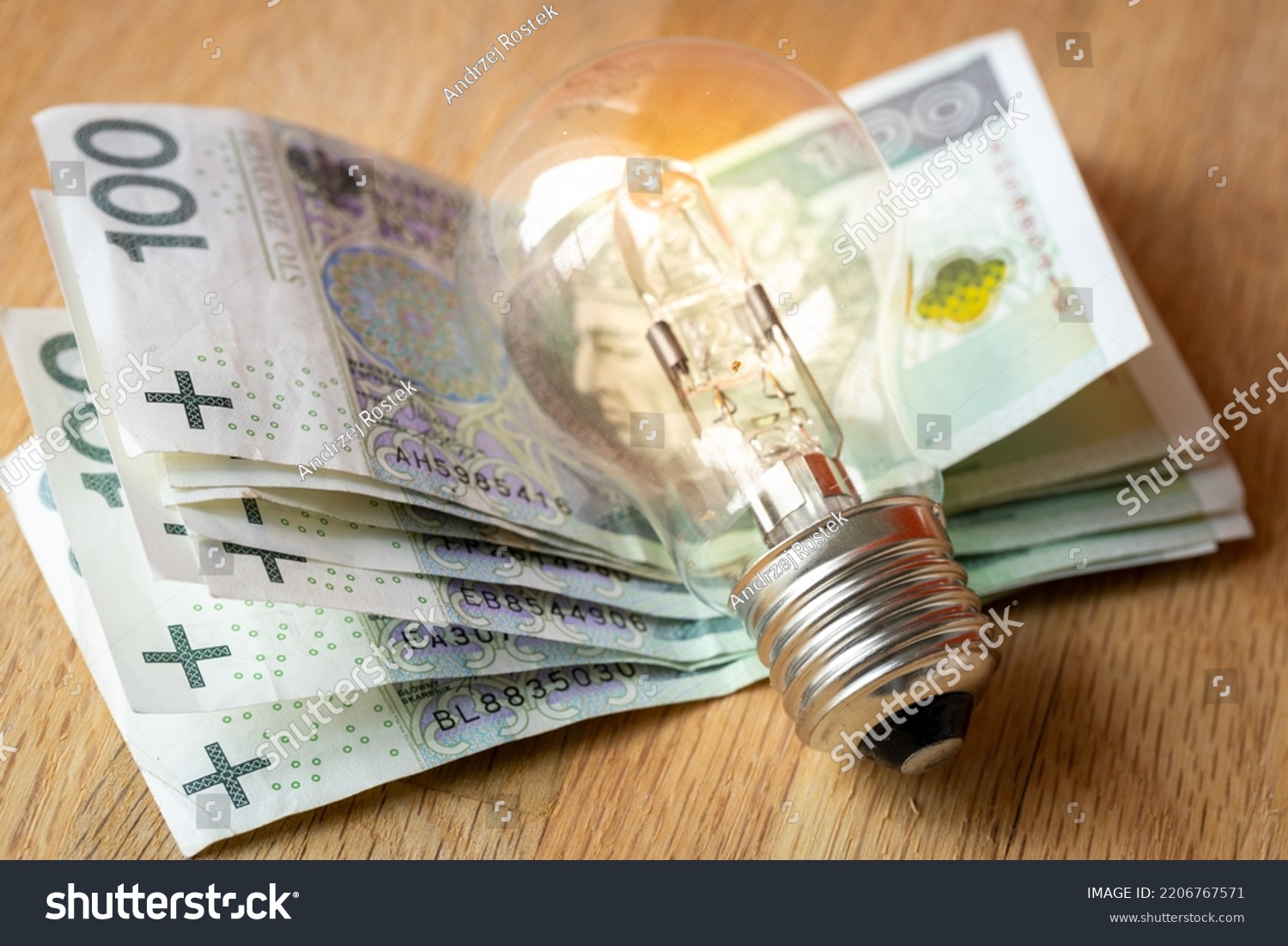 Polish money Several hundred Polish zlotys and a light bulb, the concept of increasing energy and electricity prices in Poland #2206767571