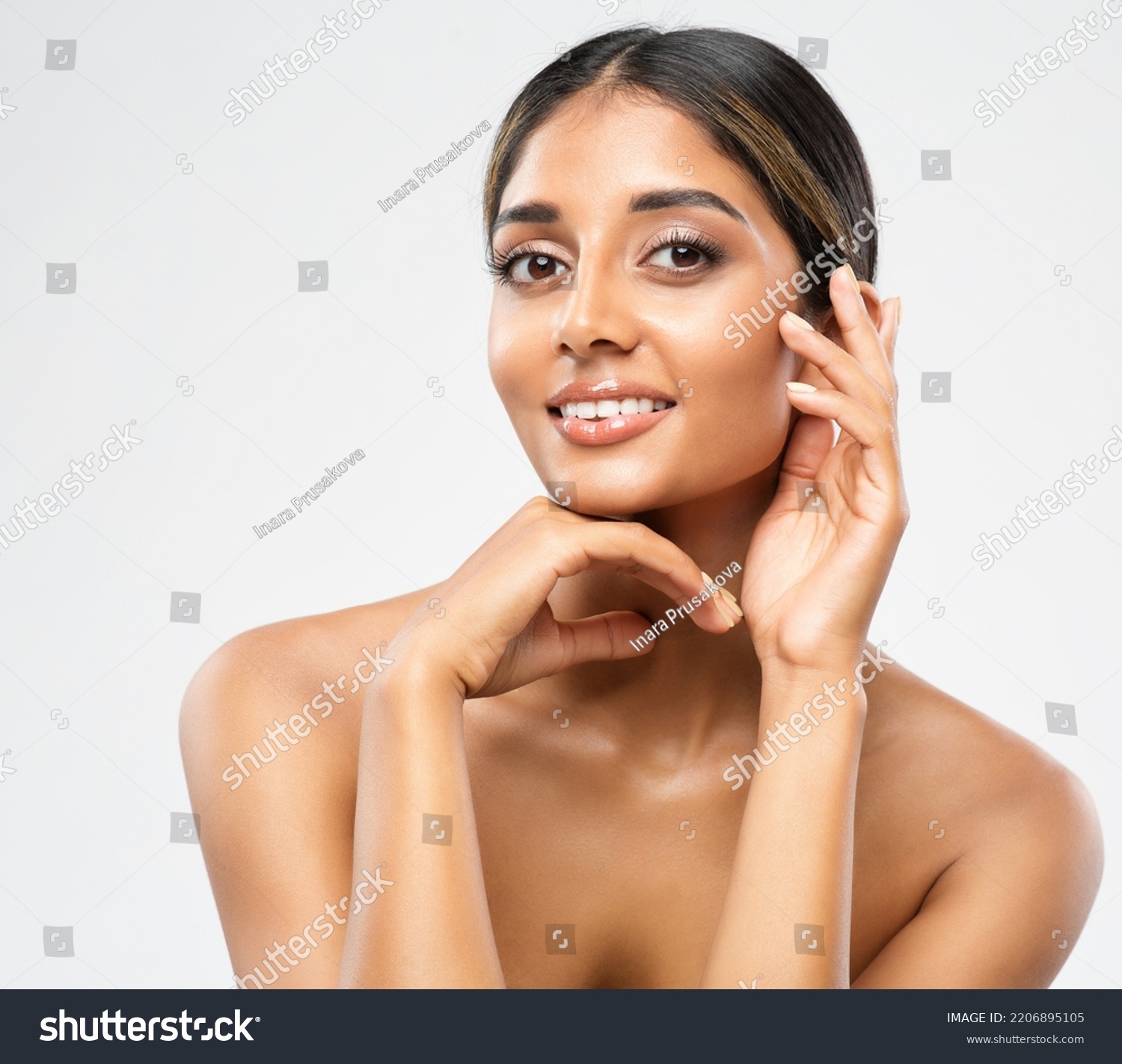 Woman Face Skin Care Cosmetic. Indian Beauty Model showing Perfect Chin and Cheekbones. Women Facial Treatment and Health. Beautiful Girl doing Anti Aging Face Lift Massage over White #2206895105