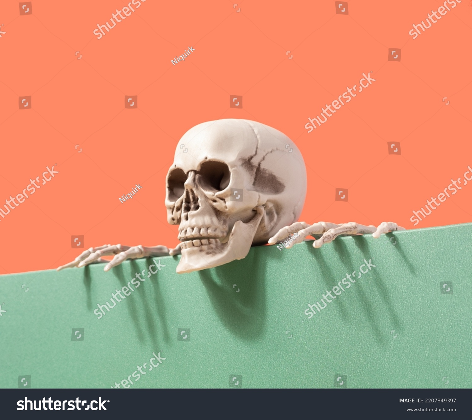 Skeleton on the edge of the table against the two-tone background. Spooky Halloween futuristic concept. Santa Muerte #2207849397