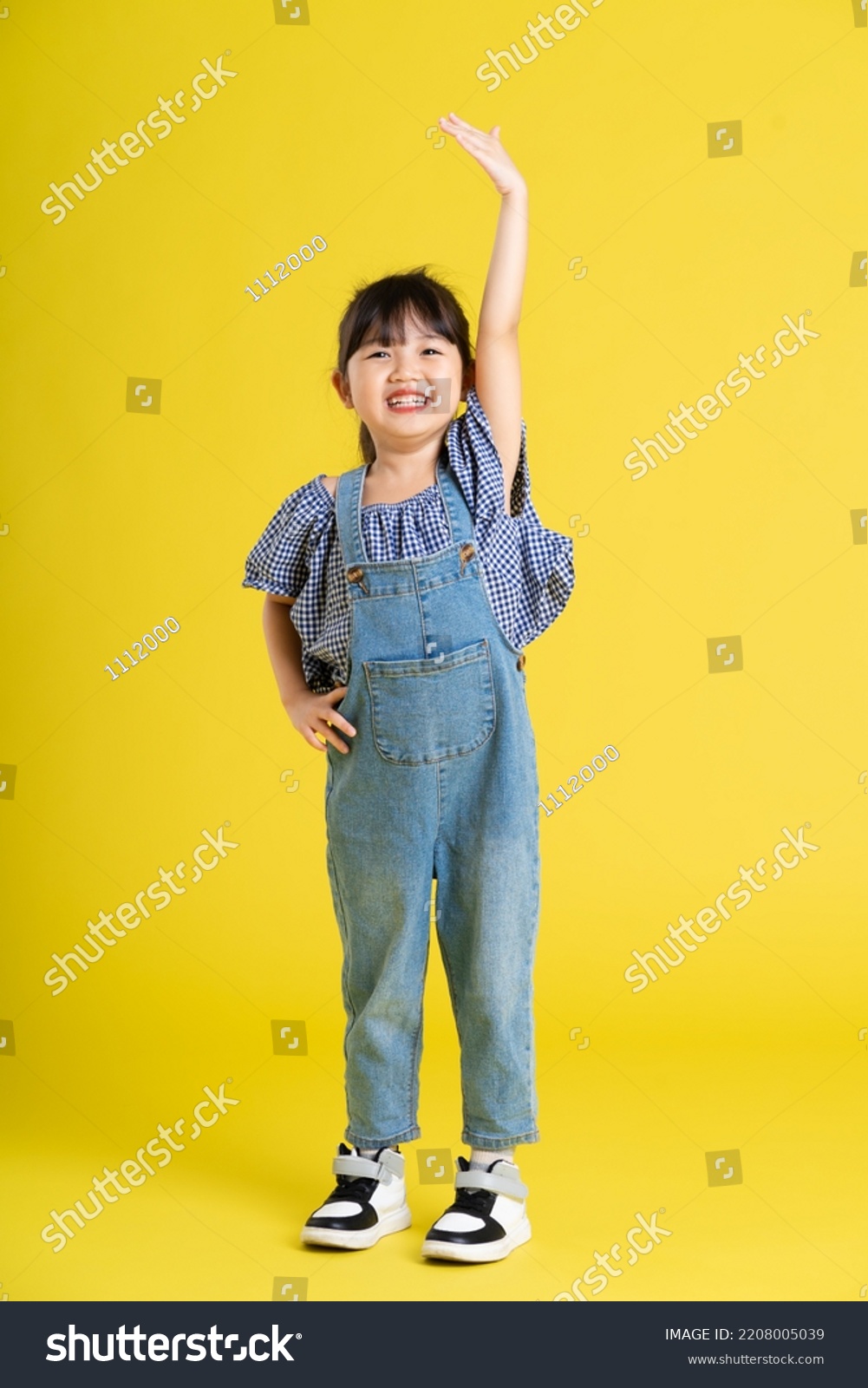full body image of beautiful asian baby girl on yellow background #2208005039