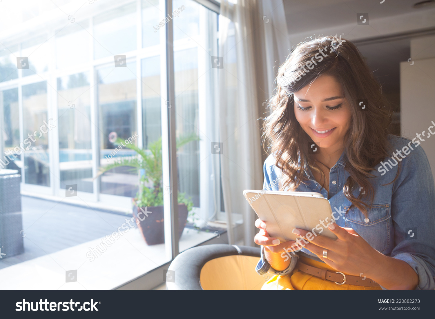 Fashion woman using tablet with sunbeams and lens flare #220882273
