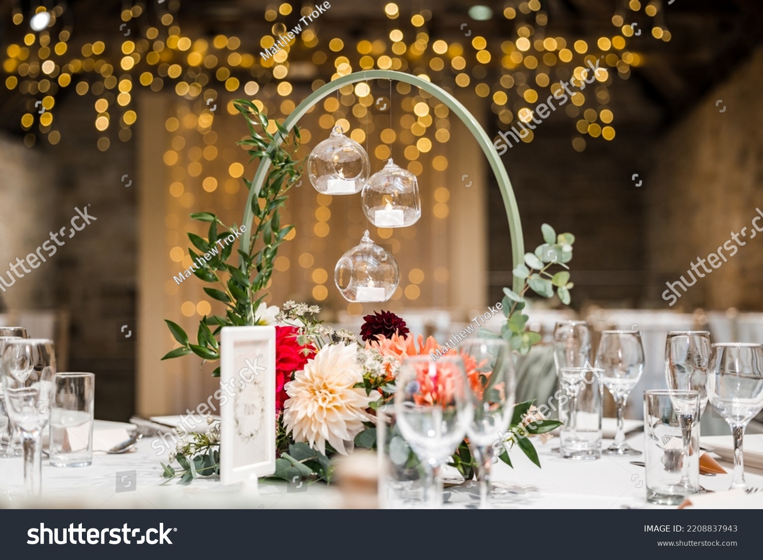 Beautiful candle light wedding table decor with flowers and out of focus twinkle lights. Wedding breakfast party. #2208837943