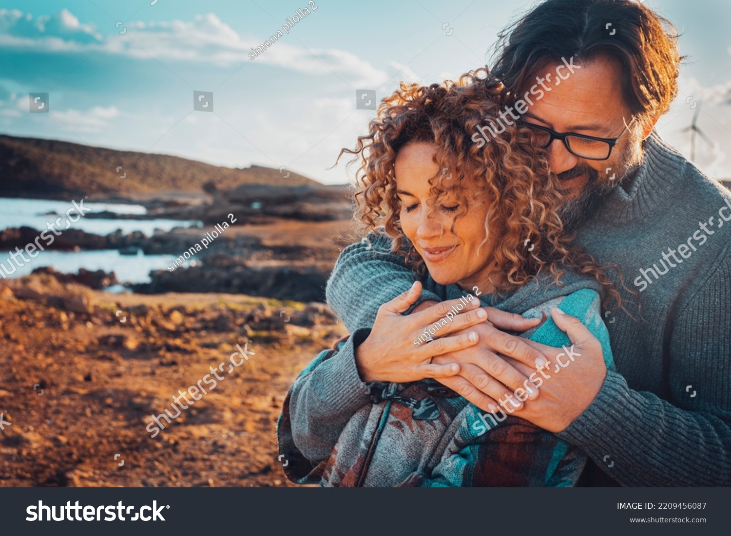 Happy young couple in love hugging outdoors with tenderness and relationship. Concept of travel lifestyle. Man and woman embracing with scenic nature background outdoors. Leisure love people vacation #2209456087