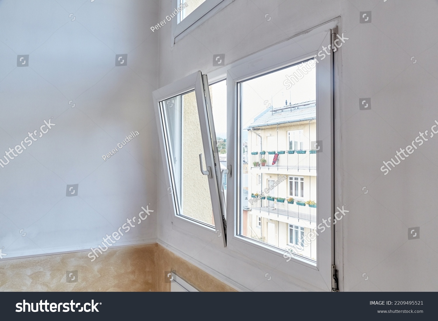 Window tilt open in a city apartment, letting in fresh air #2209495521