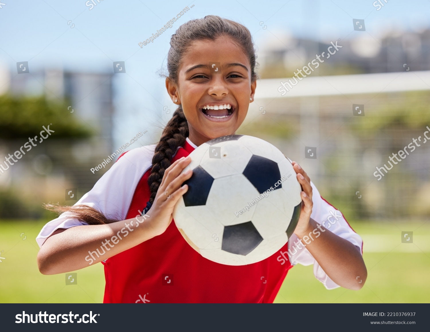 Soccer, sports and happy Indian girl athlete holding a sport ball on a school field. Portrait of fitness, football and exercise of a child smile excited about training, workout and game motivation #2210376937