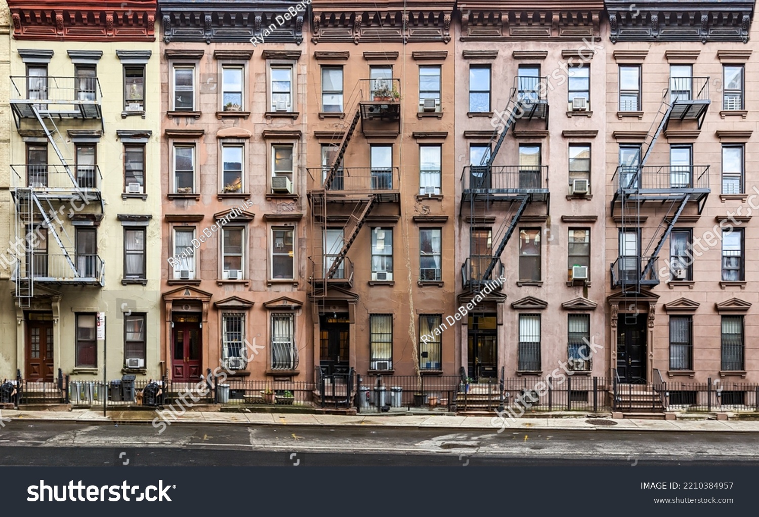 Block of historic apartment buildings crowded together on West 49th Street in the Hell's Kitchen neighborhood of New York City NYC #2210384957