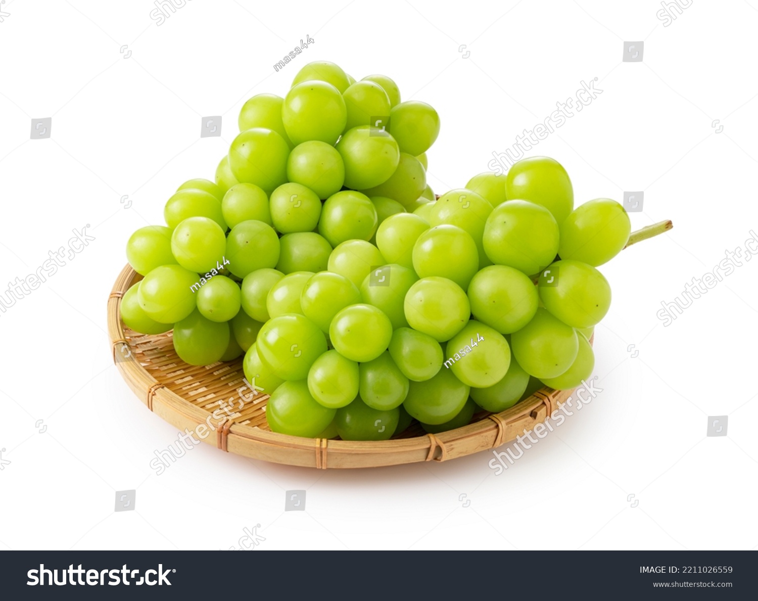 Shine Muscat in a bamboo colander on a white background. White grapes. Japanese grapes. #2211026559