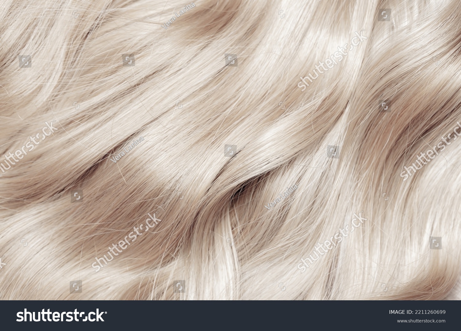 Blond hair close-up as a background. Women's long blonde hair. Beautifully styled wavy shiny curls. Hair coloring. Hairdressing procedures, extension. White hair #2211260699