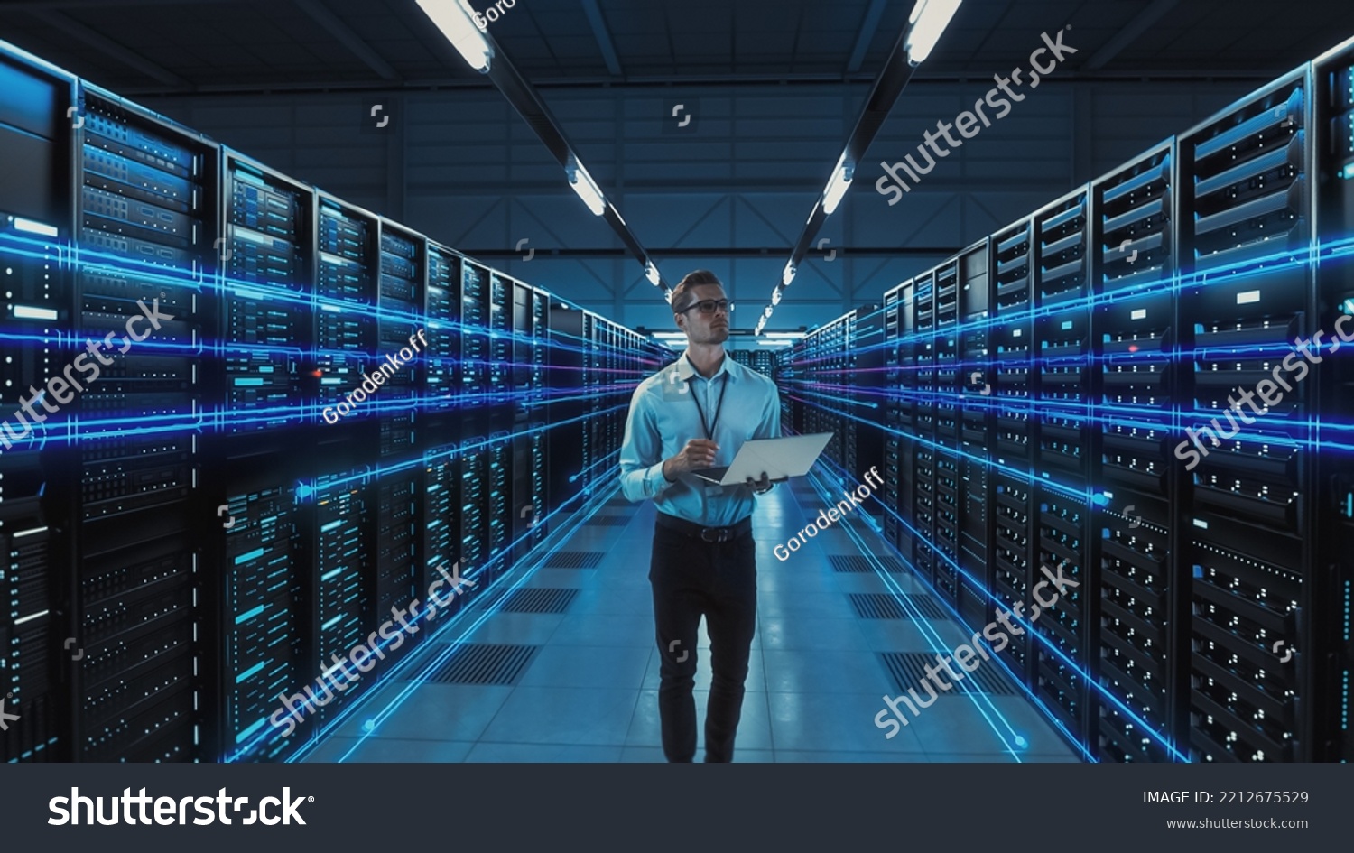 Futuristic Concept: Data Center Chief Technology Officer Holding Laptop, Standing In Warehouse, Information Digitalization Lines Streaming Through Servers. SAAS, Cloud Computing, Web Service #2212675529