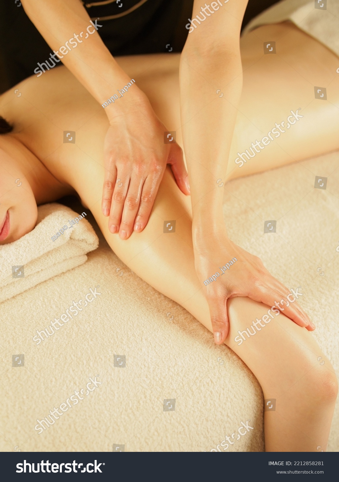 Asian female esthetician massaging her arm #2212858281
