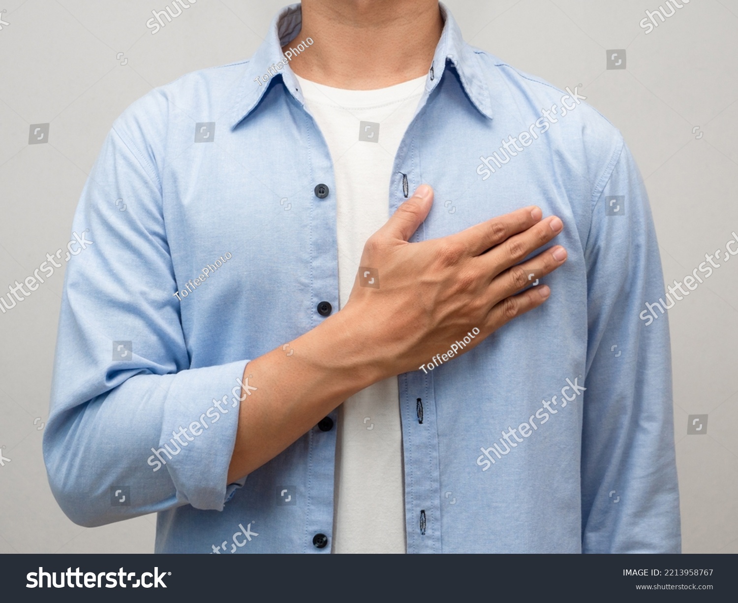 Close-up man touch his chest for lover portrait studio shot #2213958767