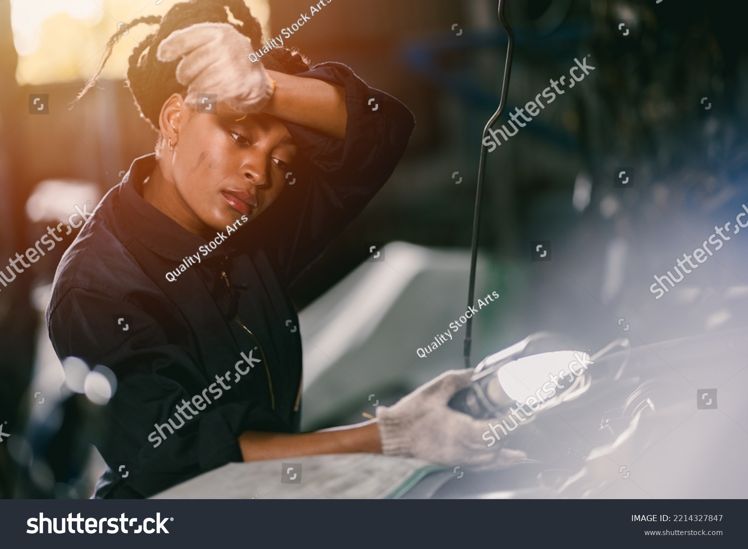 african woman worker hard working tired sweat for mechanic girl engine check garage  #2214327847