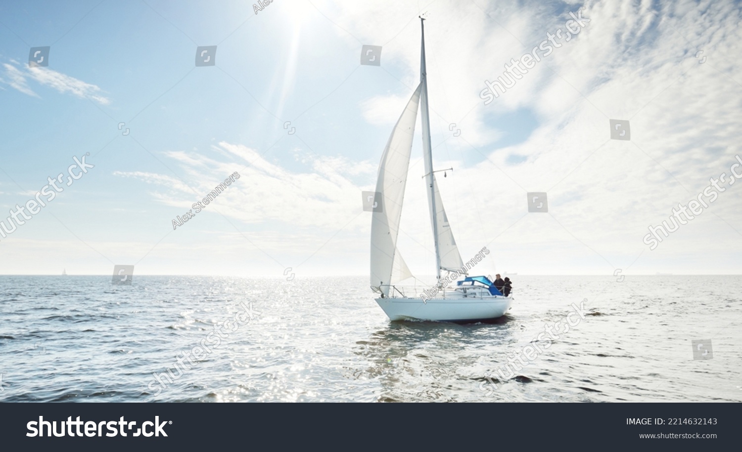 White sloop rigged yacht sailing in an open sea. Clear sky, cloudscape. A view from the sailboat. Transportation, travel, sport, recreation, leisure activity, racing, regatta. Panorama, copy space #2214632143