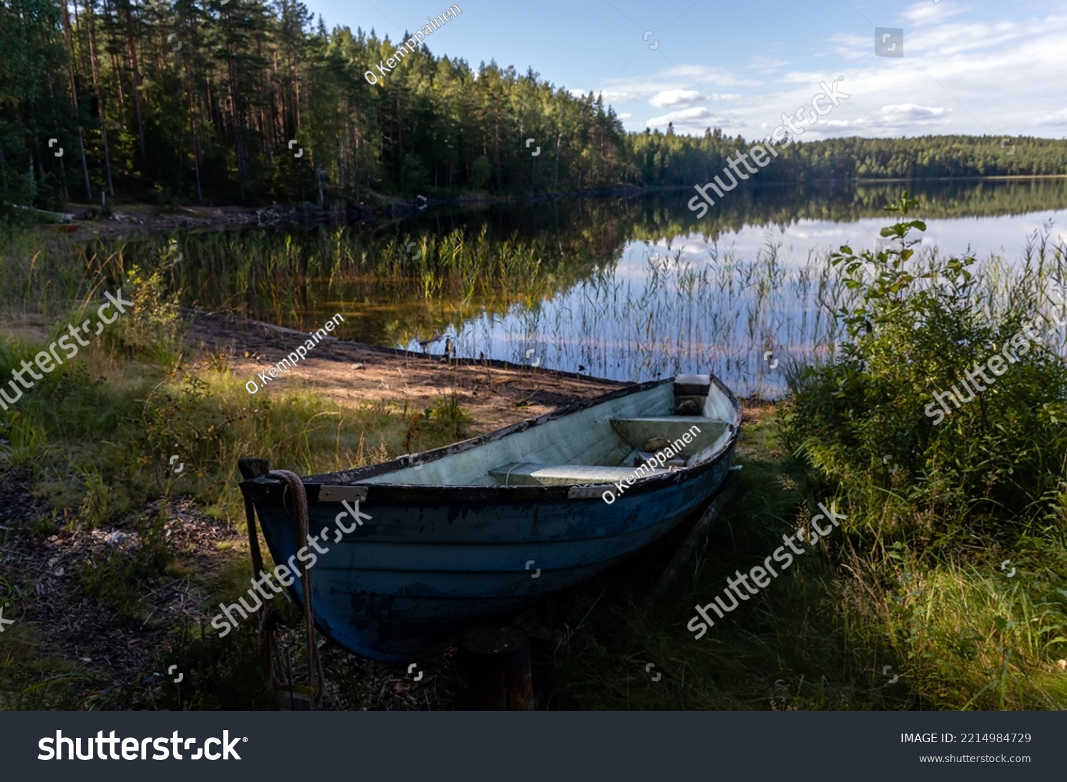 Old blue fiberglass boat on sandy beach in Repovesi National Park, Finland #2214984729