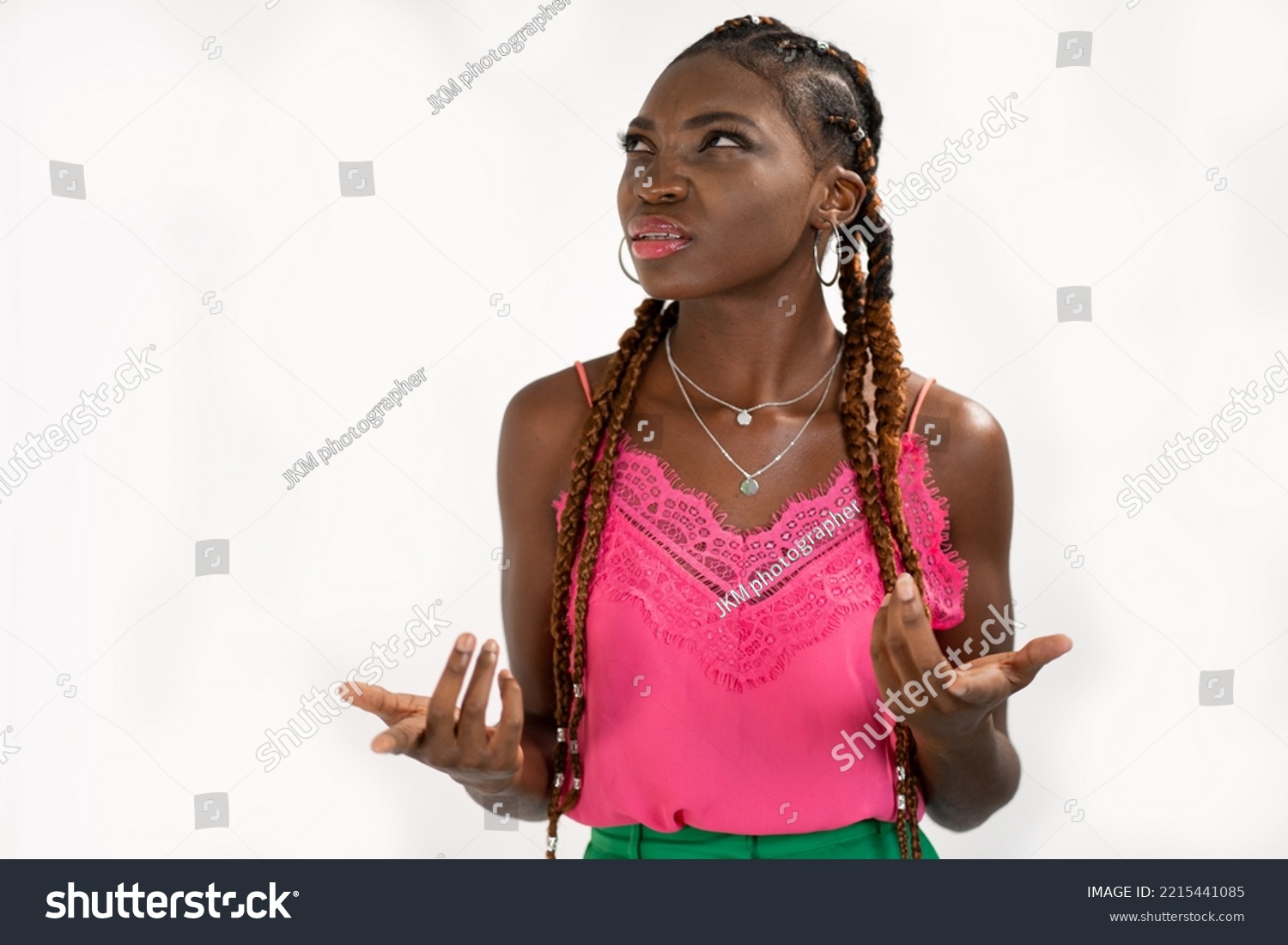 The woman who feels confused cannot understand what her friend is referring to. Portrait of dark skinned woman clueless and questioned unaware #2215441085