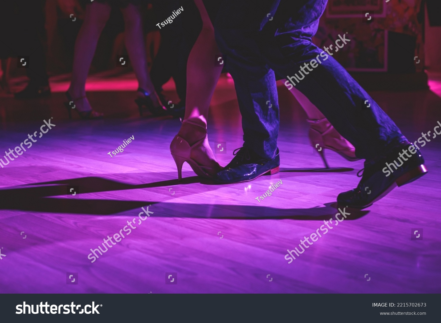 Dancing shoes of a couple, couples dancing traditional latin argentinian dance milonga in the ballroom, tango salsa bachata kizomba lesson, festival on a wooden floor, purple, red and violet lights #2215702673