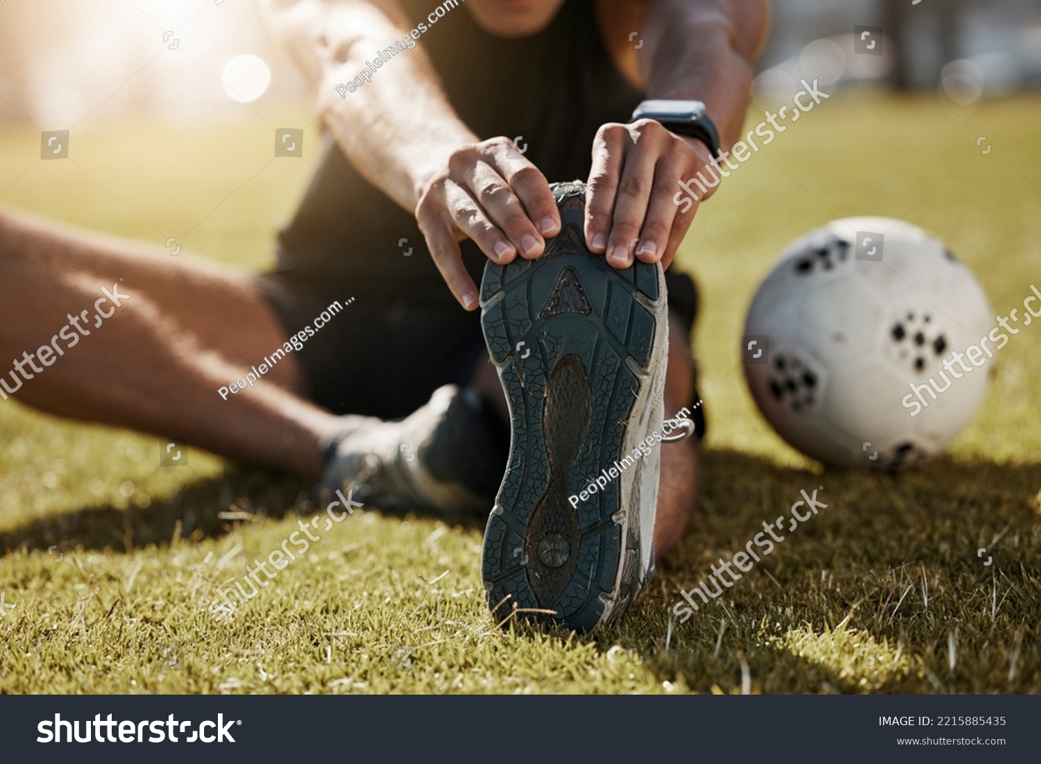 Stretching, foot and soccer man on field for sports training, exercise wellness or legs muscle health. Professional football person with sneakers or shoes for game warmup, workout outdoor on a pitch #2215885435