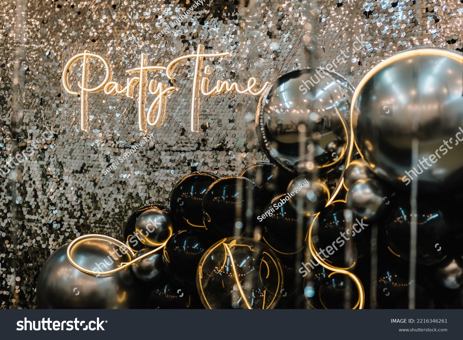 A place for congratulations for birthday. Arch or photo booth decorated black and silver balloons and led strips. Zone with decor sparkling sequins for wedding. Text party time. Happy New Year 2023. #2216346261