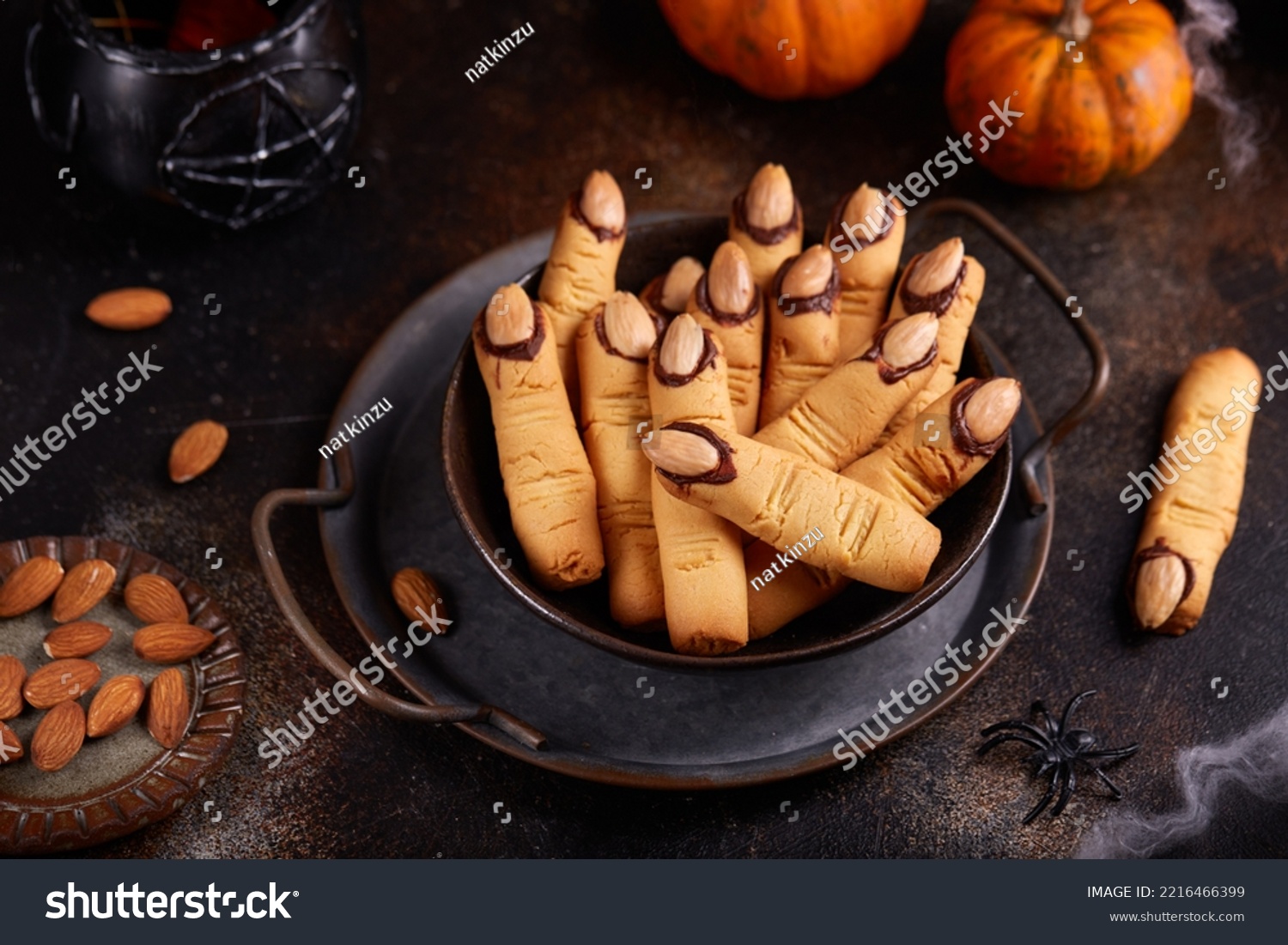 Halloween cookies witch`s fingers with chocolate and almond nuts. Delicious and scary dessert for treats. #2216466399