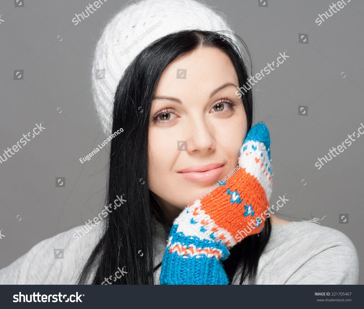 Winter Beauty Woman. Fashion Girl Concept. Skin and hair care in cold season. Beautiful woman with long hair wearing a sweater, scarf, hat and gloves. Holiday Fashion Portrait. #221705467