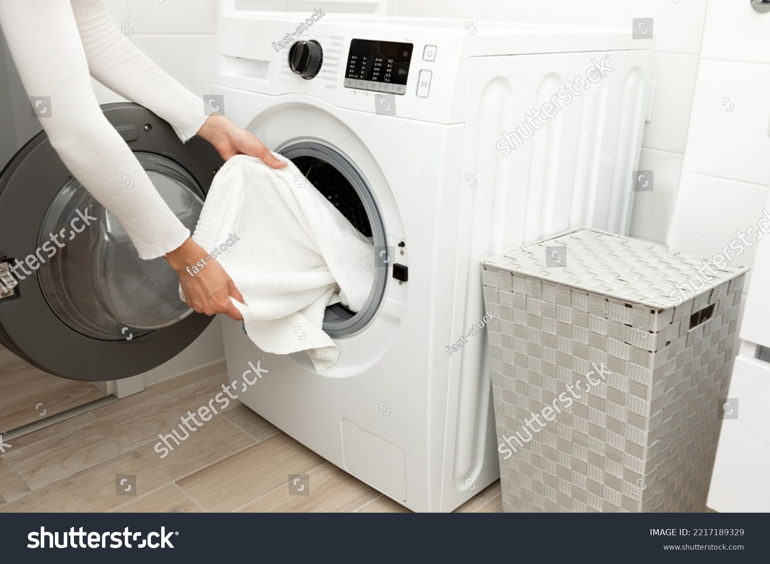 General shot of a washing machine loaded with clothes #2217189329