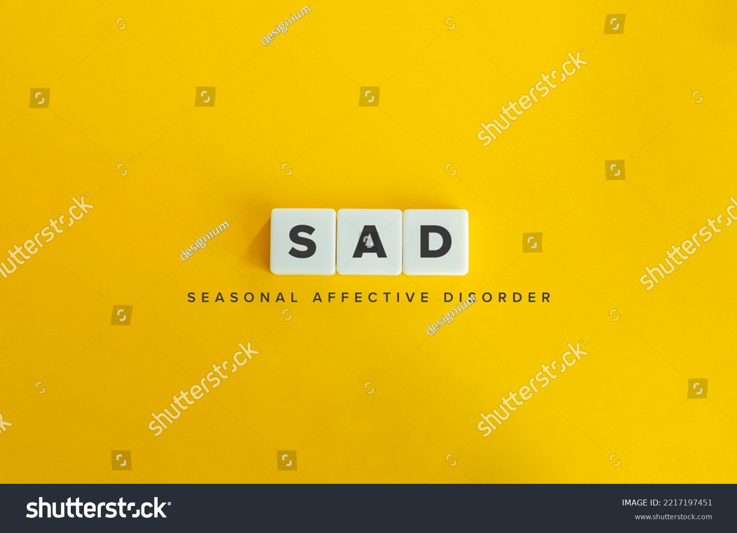 Seasonal affective disorder (SAD) banner. Winter Depression. Block Letter Tiles on Yellow Background. Minimal Aesthetics. #2217197451