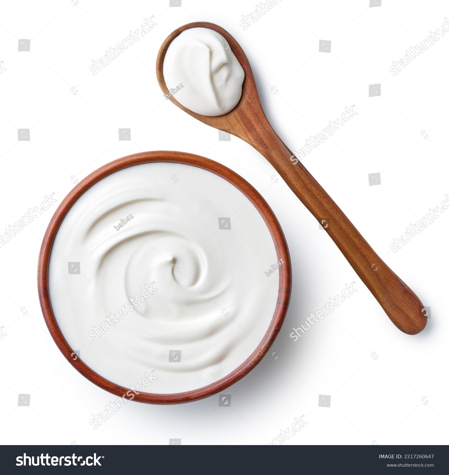 Brown ceramic bowl and wooden spoon of fresh sour cream isolated on white background, top view #2217260647