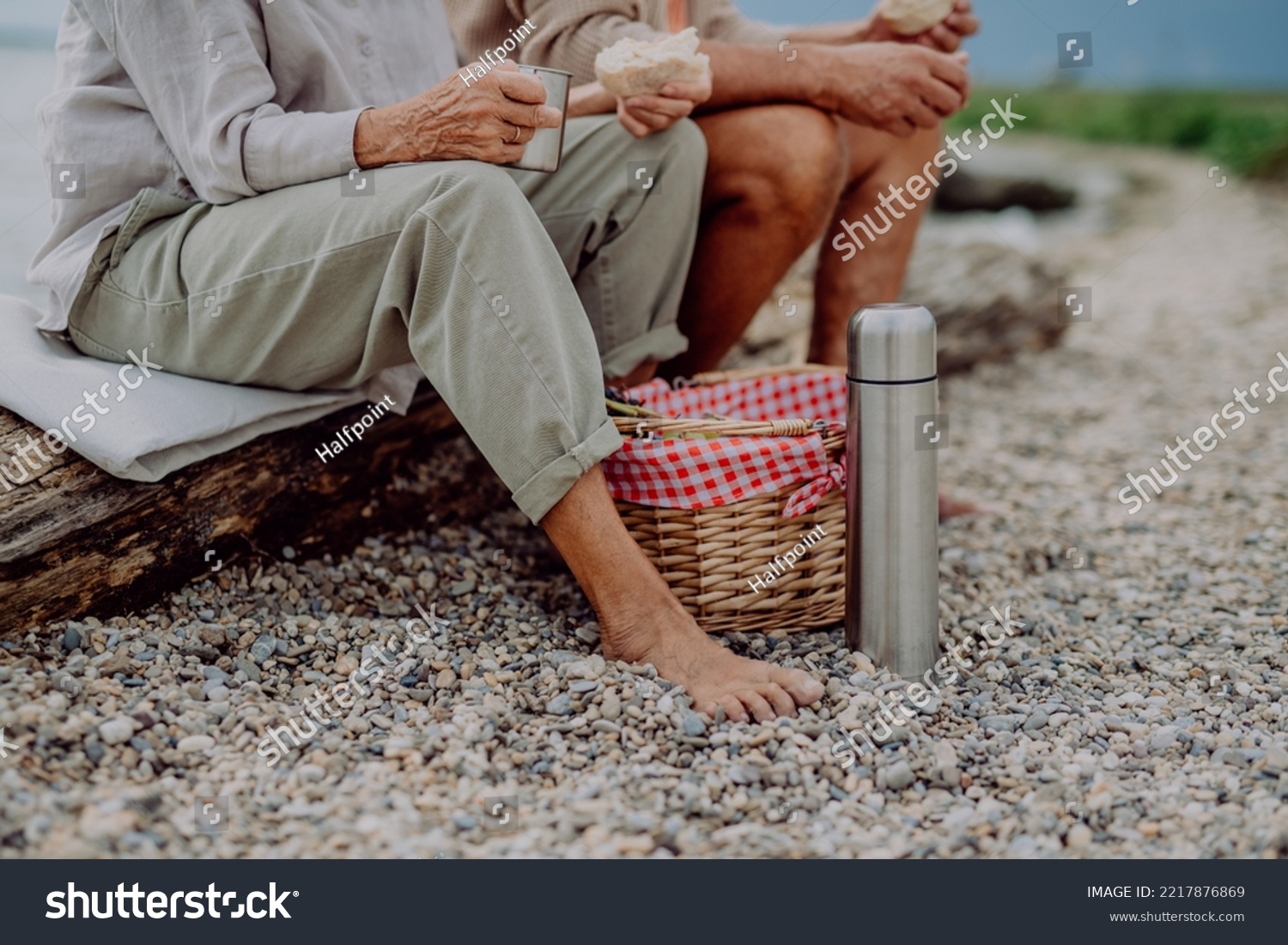 Low section of senior couple enjoying picnic outdoor near sea. #2217876869