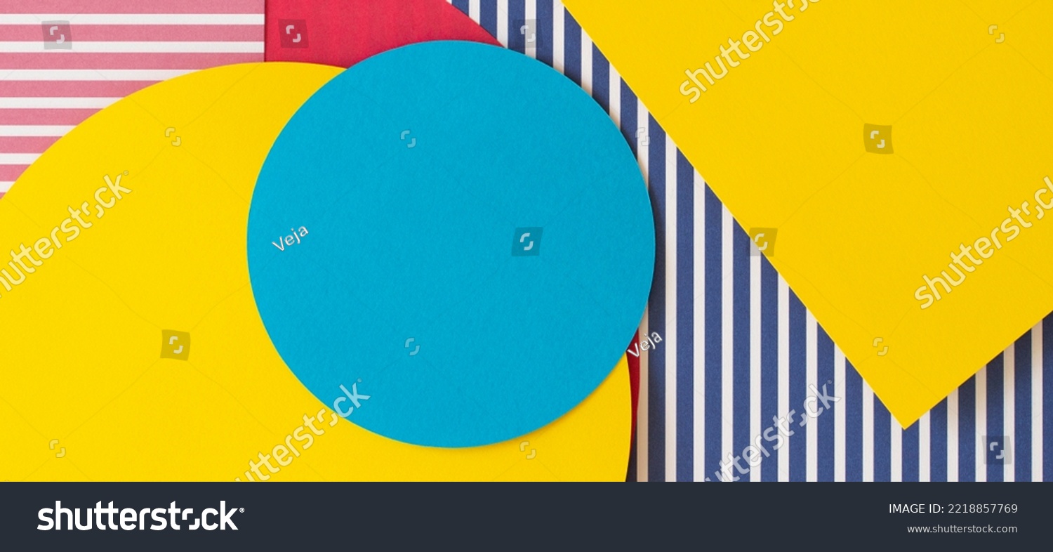 Abstract trendy fashion colored papers texture background in memphis geometry style. Yellow, red, blue, white colors. Geometric shapes and striped lines. Top view, flat lay #2218857769