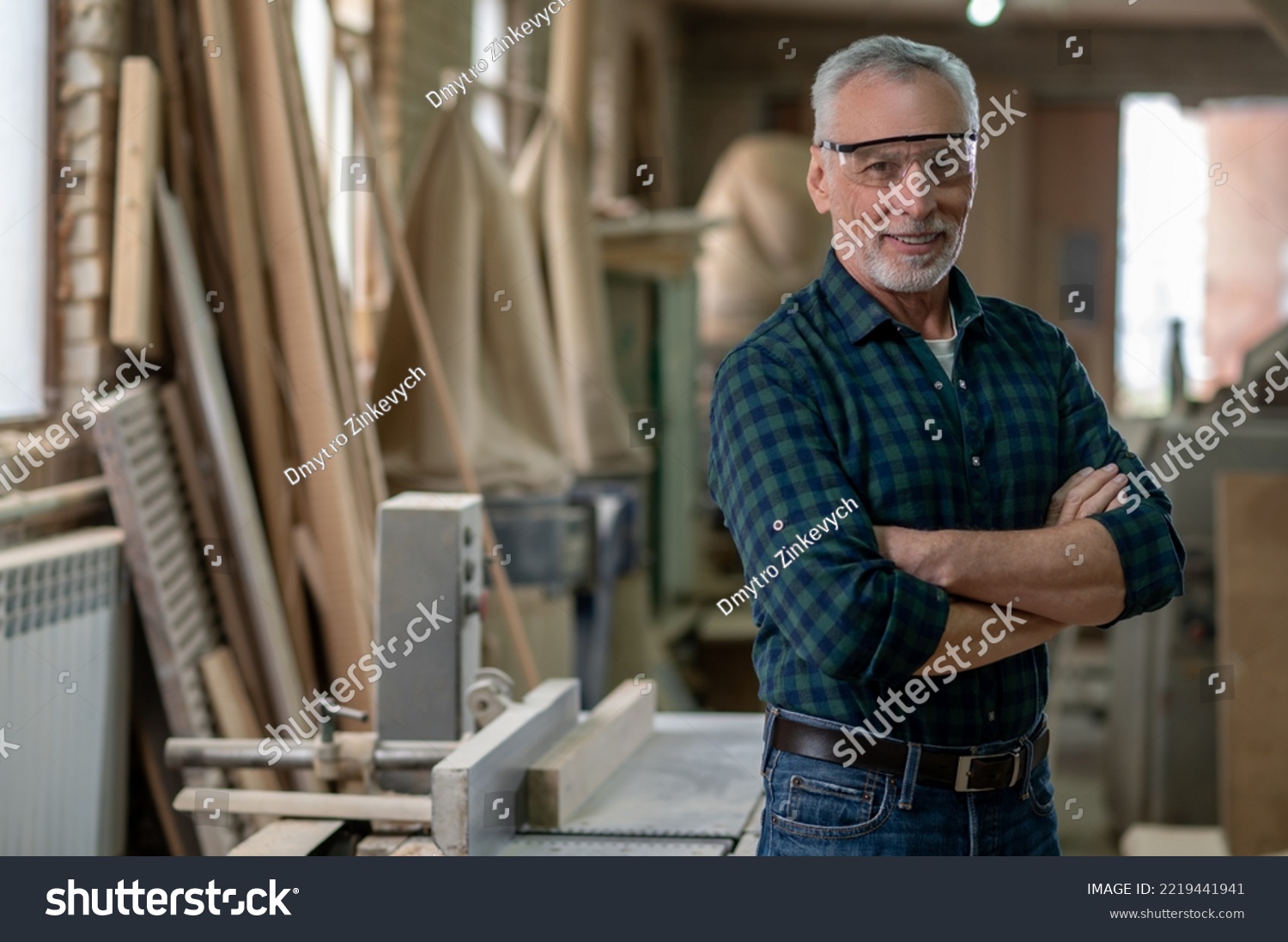 Mature man standing in a workshop and looking confident #2219441941