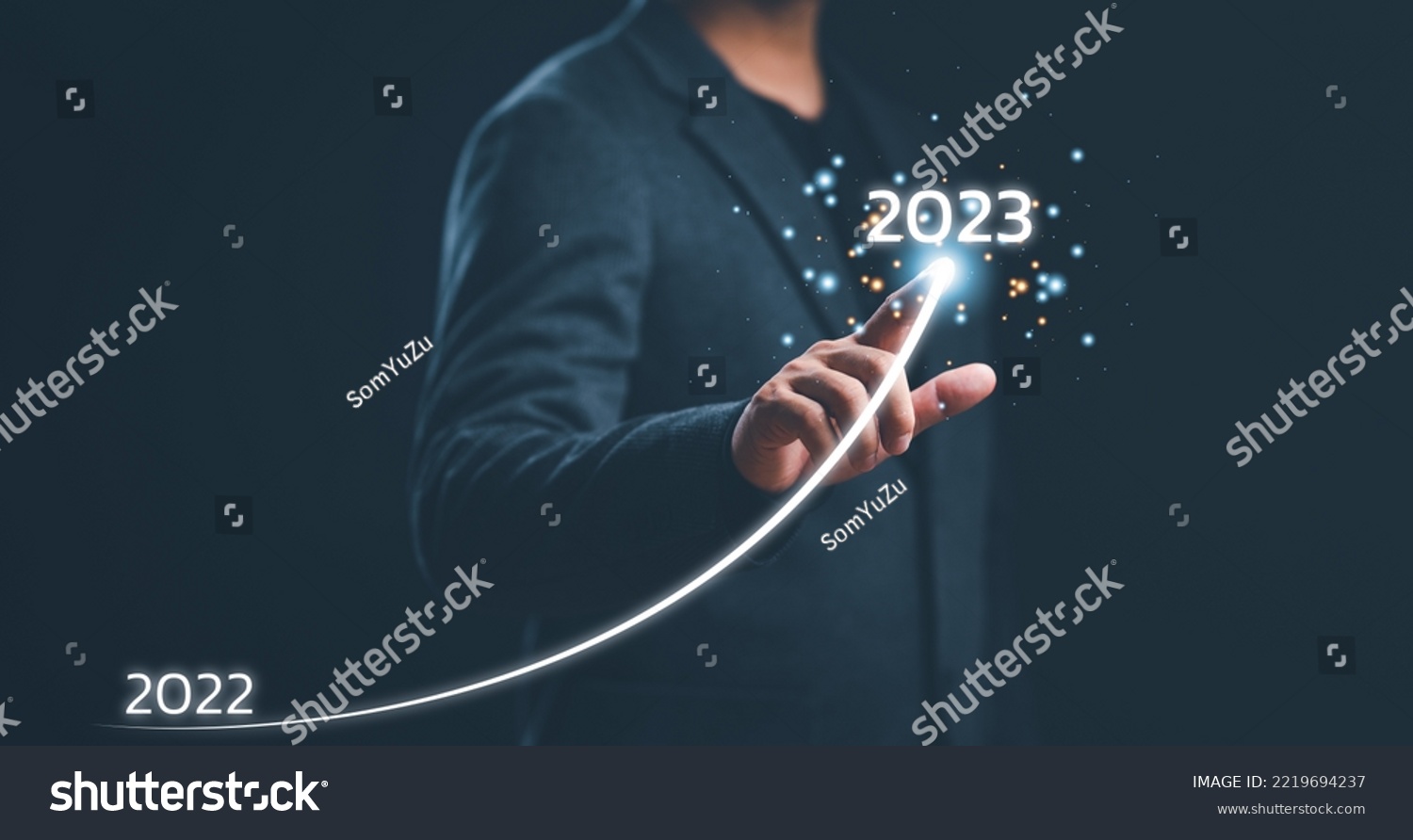 Businessman hand drawing line for increasing arrow from 2022 to 2023 for preparation merry Christmas and happy new year concept. new business, start up on new years. #2219694237