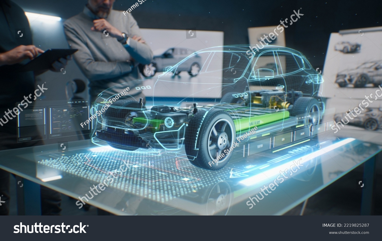 Car design engineers using holographic app in digital tablet. Develop modern innovative high-tech cutting edge eco-friendly electric car with sustainable standards. They test the aerodynamic qualities #2219825287